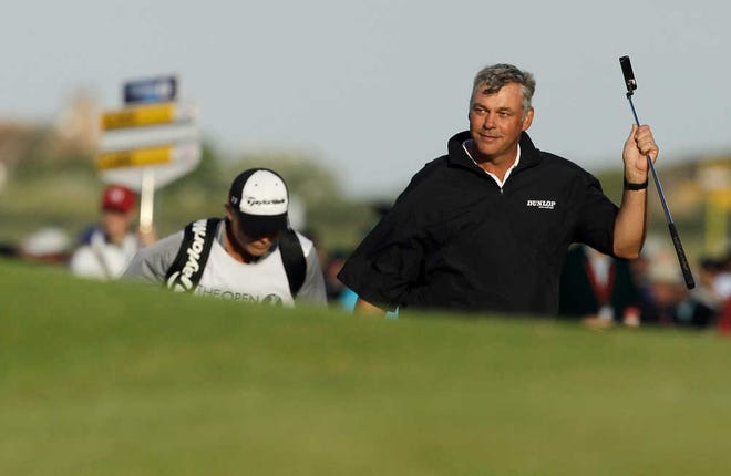 Northern Ireland's Darren Clarke walks up to the 18th green during Saturday's third round of the British Open at Royal St. George's in Sandwich, England. Clarke leads the tournament by one shot ahead of Dustin Johnson.