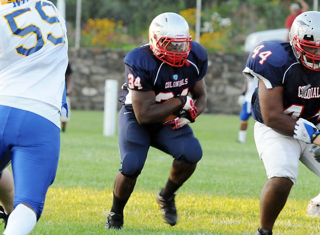 Metrowest Colonials running back Dave Taylor cuts towards an open hole on the line during the team's NEFL AAA Division matchup against the Boston Bandits at Kelleher Field in Marlborough last night.