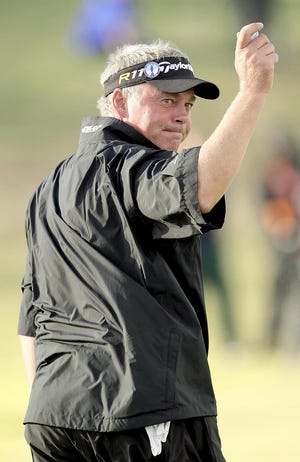 Darren Clarke waves to the gallery Saturday. He leads by a stroke entering today's final round.