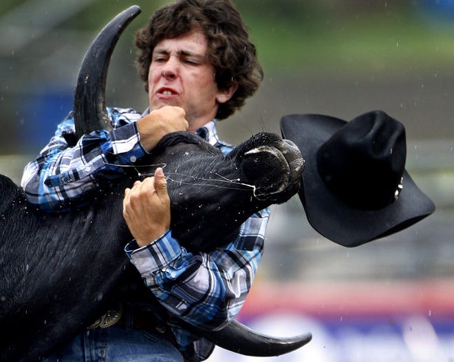 Johnny Shore of Ontario wrestles a steer during the National High School Finals Rodeo.