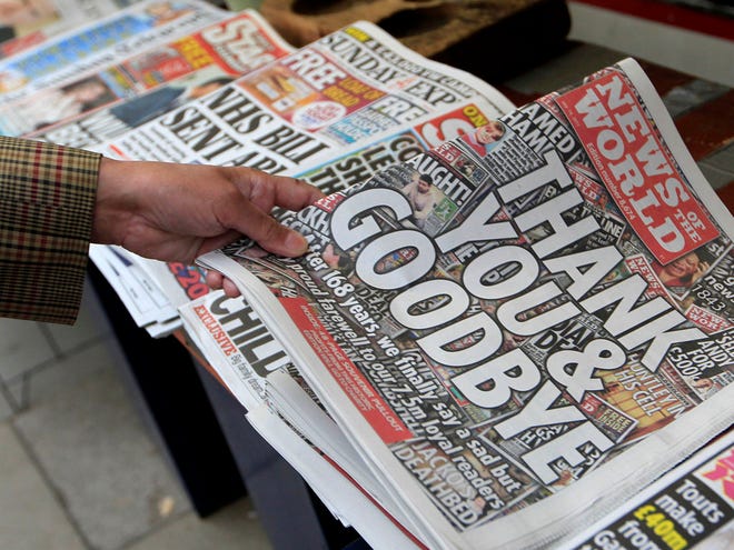 A customer buys a copy of the News of the World from a newspaper vendor in central London. A phone-hacking scandal brought down Britain's best-selling Sunday tabloid after 168 years. (AP)