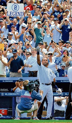 New York Yankees Derek Jeter waves to the cheers of the crowd after he hit a solo home run, his 3,000th career hit off of Tampa Bay Rays starting pitcher David Price in the third inning of a baseball game on Saturday, July 9, 2011 at Yankee Stadium in New York. (AP Photo/Kathy Kmonicek)