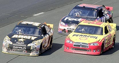 Ryan Newman passes Kurt Busch with Denny Hamlin following during the NASCAR Sprint Cup Series race Sunday at New Hampshire Motor Speedway. Newman won the race. By JIM COLE, The Associated Press