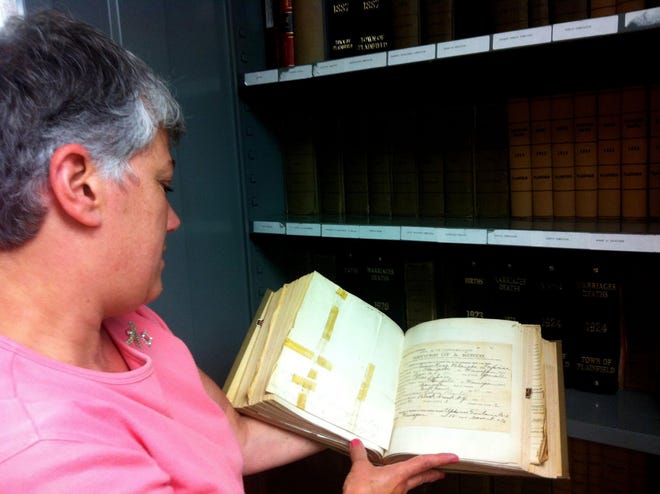 Plainfield Town Clerk Louisa Trakas shows vital records from the late 1800s. Her office has used Connecticut State Library Historic Preservation Grants to preserve some of the records. This one has not been worked on.