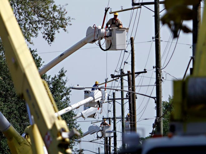 Workers with Gainesville Regional Utilities replace power lines along Northeast 15th Street on June 23, 2011, in Gainesville Fla.
