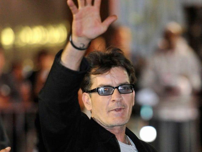 Actor Charlie Sheen waves to fans as he leaves the Chicago Theatre in Chicago on April 3. (AP Photo/Brian Kersey, File)