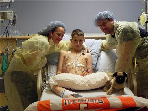 In this photo taken Thursday, July 14, 2011, Andrew Myers, 14, of Hoopeston, is seen in the intensive care unit at Children's Memorial Hospital in Chicago with his parents, Melissa and James Myers. The hospital provided the photo.
