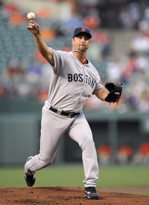 Boston Red Sox starting pitcher Tim Wakefield (49) delivers a pitch against the Baltimore Orioles during the first inning of a baseball game, Monday, July 18, 2011, in Baltimore.