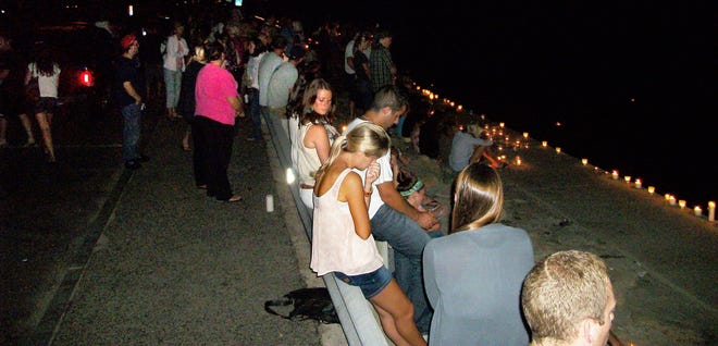 Hundreds of people attend a vigil at Brant Rock in Marshfield on Tuesday, July 19, 2011 for 23- year-old Zac Woods, who remains missing after a boating accident over the weekend.