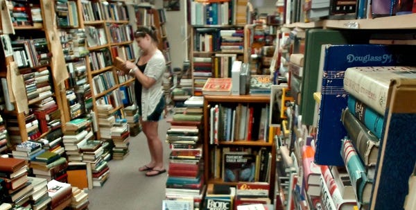 Michele Strzelczyk of Reeders browses through books at Carroll & Carroll Booksellers in Stroudsburg on Tuesday. The local bookstore remains in business while big-chain retailer Borders will close all of its remaining stores.   To purchase a reprint of this photo, go to  www.PoconoRecord.com/phototstore.