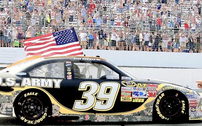 Ryan Newman drives through the pit area with a U.S. flag Sunday after winning the NASCAR Sprint Cup Series auto race at New Hampshire Motor Speedway. By CHERYL SENTER, The Associated Press