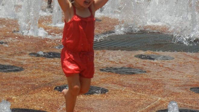 2-year-old Aubrey playing in the fountain on Clematis