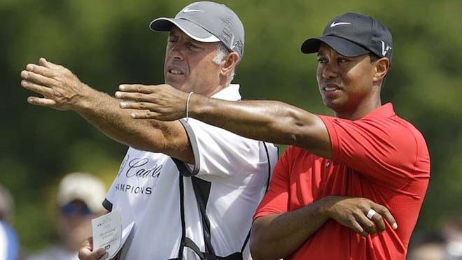 This March 13, 2011, file photo shows Tiger Woods' caddie Steve Williams (left) and Woods lining up a putt on the fourth hole during the final round at the Cadillac Championship golf tournament in Doral. Woods has decided to get rid of Williams as his caddie. Woods announced on his website Wednesday, July 20, 2011, that he and Williams, who have been together since March 1999, will no longer be working together.