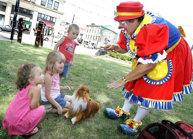 Carlee the clown (Sherri Shepard) entertains Mariah Thornton, 2, Megan Billman, 5,and Brandon Billman, 3, with her "pet" marionette dog and tricks it can perform.
