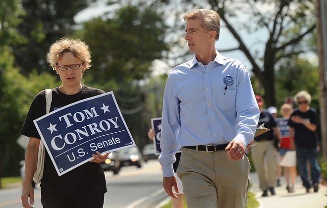 State Rep. Tom Conroy, D-Wayland, walks on Route 20 in Wayland with supporter Sabine von Mering of Wayland and other supporters