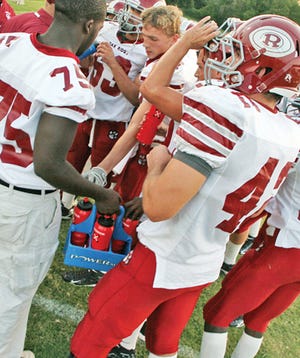 Oak Ridge High School football players grab water during a timeout last year during Week 1 of the football season.