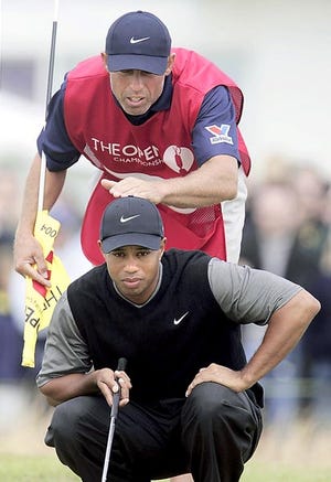This July 17, 2004, file photo shows Tiger Woods and his caddie, Steve Williams, lining up a putt on the second green during the British Open in Troon, Scotland. Woods announced on his website Wednesday, July 20, 2011, that he and Williams, who have been together since March 1999, will no longer be working together. AP Photo