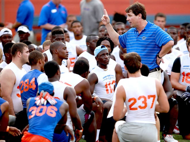 Florida football coach Will Muschamp talks with players during Friday Night Lights at Ben Hill Griffin Stadium on Friday.