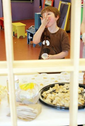 EJ Hersom/Staff photographer
William Littlefield, 6, tries out a gluten free popcorn sample at the Children's Museum of New Hampshire in Dover Wednesday.