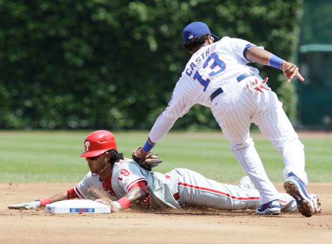 Philadelphia Phillies' Michael Martinez, left, steals second base as Chicago Cubs shortstop Starlin Castro applies a late tag during the first inning of a baseball game on Wednesday, July 20, 2011, in Chicago.