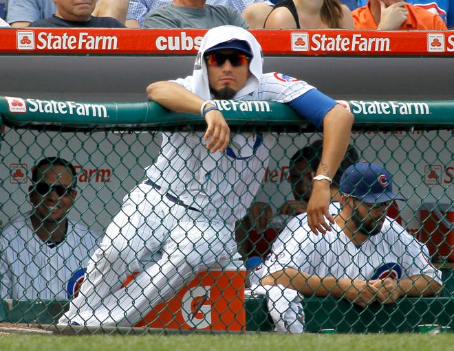 Chicago Cubs pitcher Matt Garza sits in the dugout with a towel over his head during the eighth inning of a baseball game against the Houston Astros, Saturday, July 23, 2011 in Chicago. The Cubs won 5-1.