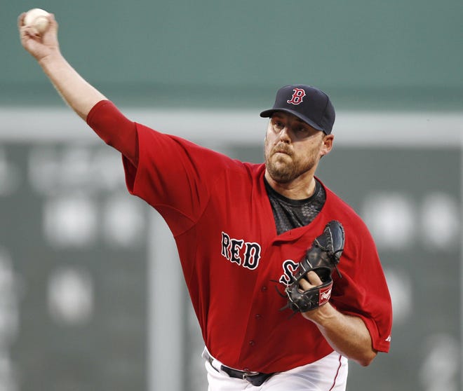 Boston Red Sox starting pitcher John Lackey delivers against the Seattle Mariners during the first inning of a baseball game at Fenway Park in Boston, Friday, July 22, 2011.