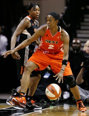 West's Swin Cash, right, drives around East's Cappie Pondexter during the first half of the WNBA All-Star game Saturday in San Antonio. Cash was named MVP with 21 points and 12 rebounds, but the East won, 118-113.