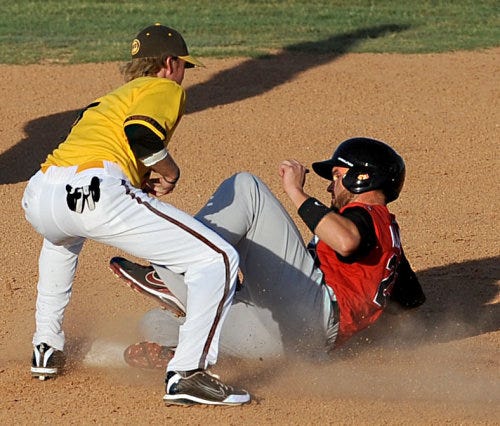 Grand Prairie AirHogs' Josh Alons slides into the tag of Amarillo Sox shortstop Jason White during their American Association game Saturday night at Amarillo National Bank Sox Stadium. The Sox won, 3-2.