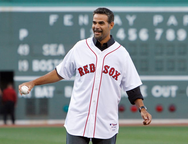 Former Boston Red Sox Mike Lowell gets ready to throw out the first pitch in before a baseball game between the Boston Red Sox and the Seattle Mariners in Boston, Saturday, July 23, 2011. (AP Photo/Michael Dwyer)