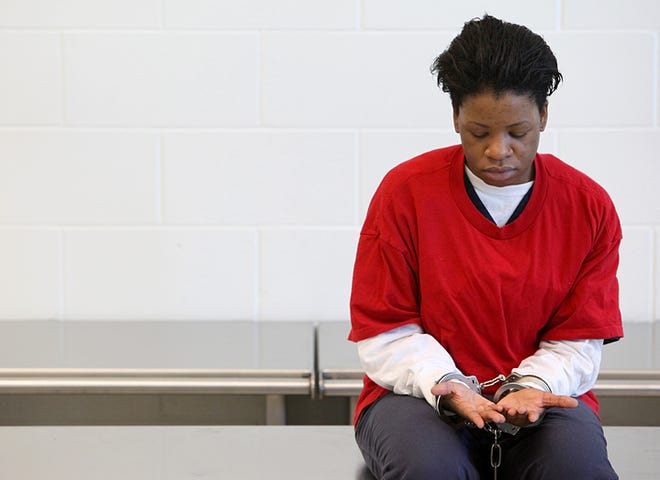 Latoya Jordan looks at her hands while awaiting her first appearance to begin in the St. Johns County Jail on Saturday morning. Jordan is charged with homicide in the death of Daniel Somerson, the man who was killed violently in his Fruit Cove home. Photo by DARON DEAN, daron.dean@staugustine.com