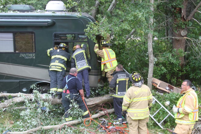 Emergency workers work to extricate a Florida man from an RV that crashed on Interstate 495 on Sunday.