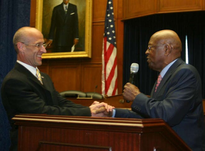 Vincent S. Chiaramonte shakes hands with U.S. Congressman Edolphus “Ed” Towns of New York during the unveiling of Chiaramonte’s portrait of him in May in Washington D.C.