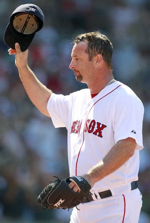 Boston's Tim Wakefield tips his cap as he comes off the field in the sixth inning.