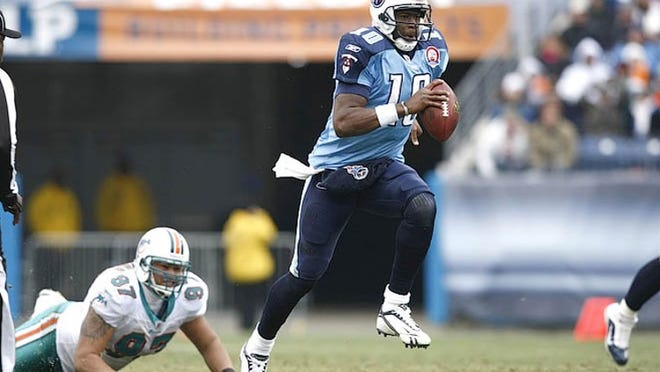Vince Young escapes the Dolphins' pass rush and races for yardage during the Titans' overtime win Dec. 20, 2009.