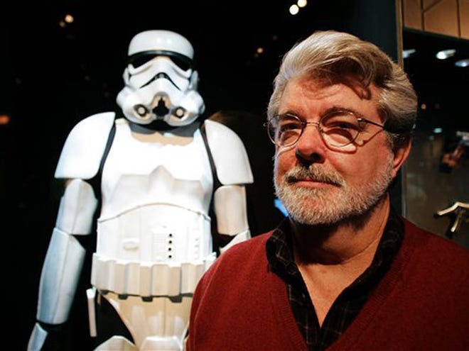 FILE - In this Oct. 22, 2005 file photo, filmmaker George Lucas poses in front of a Stormtrooper exhibit at the Museum of Science in Boston, prior to the opening of "Star Wars: Where Science Meets Imagination,". Britain's Supreme Court on Wednesday, July 27, 2011 delivered a mixed ruling in the epic battle between George Lucas' movie empire and a prop designer over the iconic stormtrooper helmets from the "Star Wars" films. Lucasfilm Ltd. has been trying to stop Andrew Ainsworth from selling replica costumes over the Internet. Ainsworth sculpted the galactic warriors' white helmets for the original "Star Wars" film in 1977. (AP Photo/Winslow Townson, File)