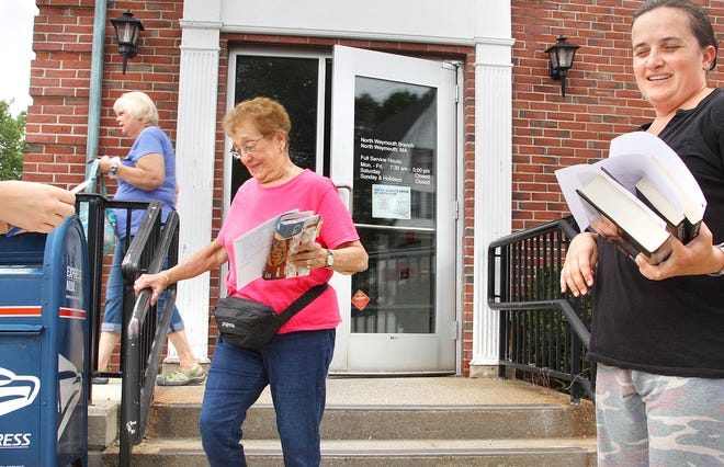 Tina Lungari, 82, center, leaves the North Weymouth Post Office as Melina Traianova, 36, North Weymouth, right, gets ready to ship books from there. News that the North Weymouth Post Office may close, draw varied reactions by customers outside the post office,Tuesday, July 26, 2011.
