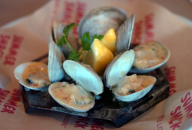 Grilled clams with garlic butter, prepared by Jasper White at his Hingham restaurant, Summer Shack.