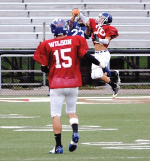 July 23, 2011 : Canton, OH
Lake's Wes Wilson (15) watches as teammate Dan Reed makes the first of his two interceptions, leaping in front of an East receiver in the end zone. The other interception came on a tipped pass in the final minute and set up a 1-yard touchdown run by Jackson?fs Will Logan to close out the scoring for the West. Over 6,000 fans watched the West defeat the East 20-12 at the Annual Canton Repository Stark county All Star game.