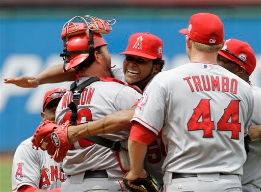 Los Angeles Angels starting pitcher Ervin Santana, center, gets a hug from catcher Bobby Wilson after throwing a no-hitter in a 3-1 win over the Cleveland Indians. First baseman Mark Trumbo (44) joins in at right.