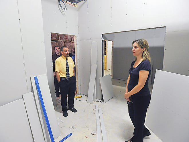 Architect Jeffrey Metcalfe, left, talks with Kim Matthews, executive director of Taunton Community Access and Media, at the local cable access station’s new building, located at 120 Ingell St. in Taunton.