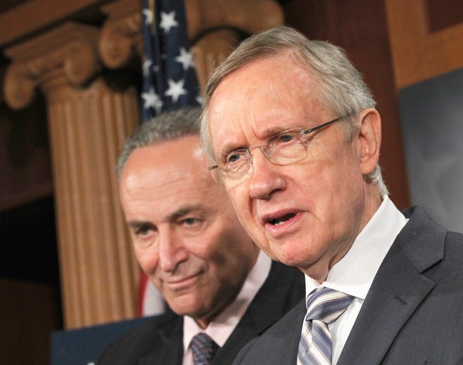 Senate Majority Leader Harry Reid of Nev., right, joined by Sen. Charles Schumer, D-N.Y., speaks at a news conference on Capitol Hill in Washington on Wednesday to discuss the conflicting plans to deal with the debt crisis.