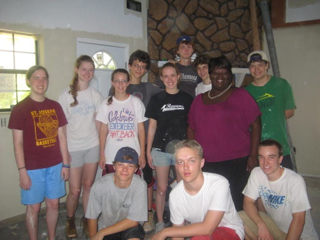 Some members of the Senior High Youth Group at The Congregational Church of Needham stopped for a photo with a homeowner, Bathsheba, in Biloxi, Miss. They are standing in one of the five homes the youth worked on during their weeklong mission trip to the Hurricane Katrina-damaged area. A worship service recounting their trip will be held on Sunday, July 31 at 10a.m. –all are welcome to attend to hear the inspirational stories from this trip.