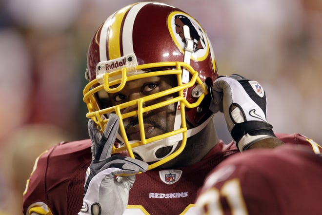In this Sept. 12, 2010 file photo, Washington Redskins defensive tackle Albert Haynesworth looks on before the start of an NFL football game against the Dallas Cowboys in Landover, Md. A person familiar with the deal says Haynesworth was shipped to the New England Patriots on Thursday for a 2013 fifth-round draft pick, a relatively small piece of compensation for a two-time All-Pro with one of the most lucrative contracts in NFL history.