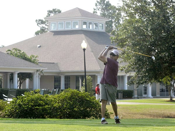 Golfer Mike Megliola practices his long game at Magnolia Green Golf Plantation. The club is planning to add a golf academy building next to the driving range to better teach local golfers.