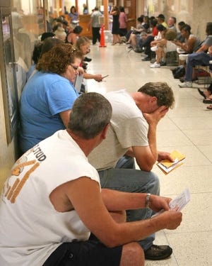 The stress of waiting in long lines for license and vehicle registration was evident in the body language of several customers waiting outside the Shawnee County Treasurer's office Thursday morning. In a meeting room one floor above the long lines, a local labor official told county commissioners that the long waits created stressful situations that also adversely affected the county employees he represents.