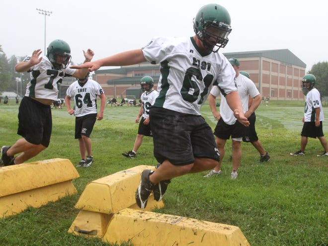 Members of the East Henderson football team take part in the first day of practice last year.