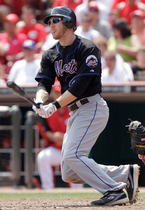 New York Mets’ Jason Bay gets a hit off Cincinnati Reds relief pitcher Jose Arredondo in the seventh inning on Thursday. Bay had three hits and three RBIs, helping the Mets to a 10-9 win.