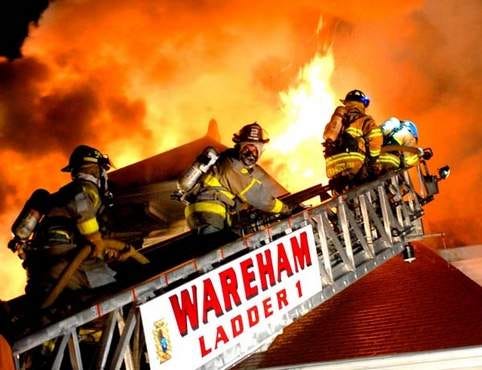 Heavy flames tear through the roof of the Harborview Inn at 13 South Boulevard in the Onset section of Wareham (Photo by David G. Curran)