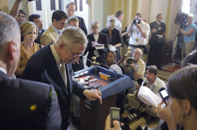 Senate Majority Leader Harry Reid of Nev., steps away from the microphone after speaking to reporters during a news conference on Capitol Hill in Washington, Friday.