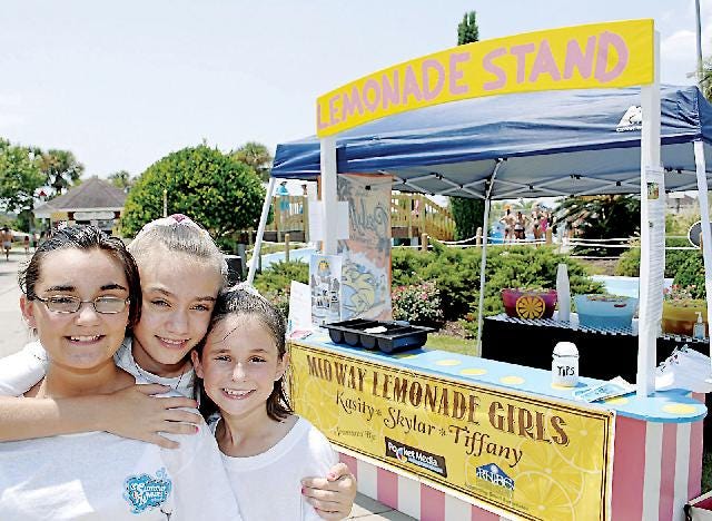 Terry Dickson/Florida Times-Union Kasity Dixon, left, her sister Skylar Robert, right, and their cousin Tiffany Cassin pose for a picture Sunday at their lemonade at SummerWaves waterpark on Jekyll Island.